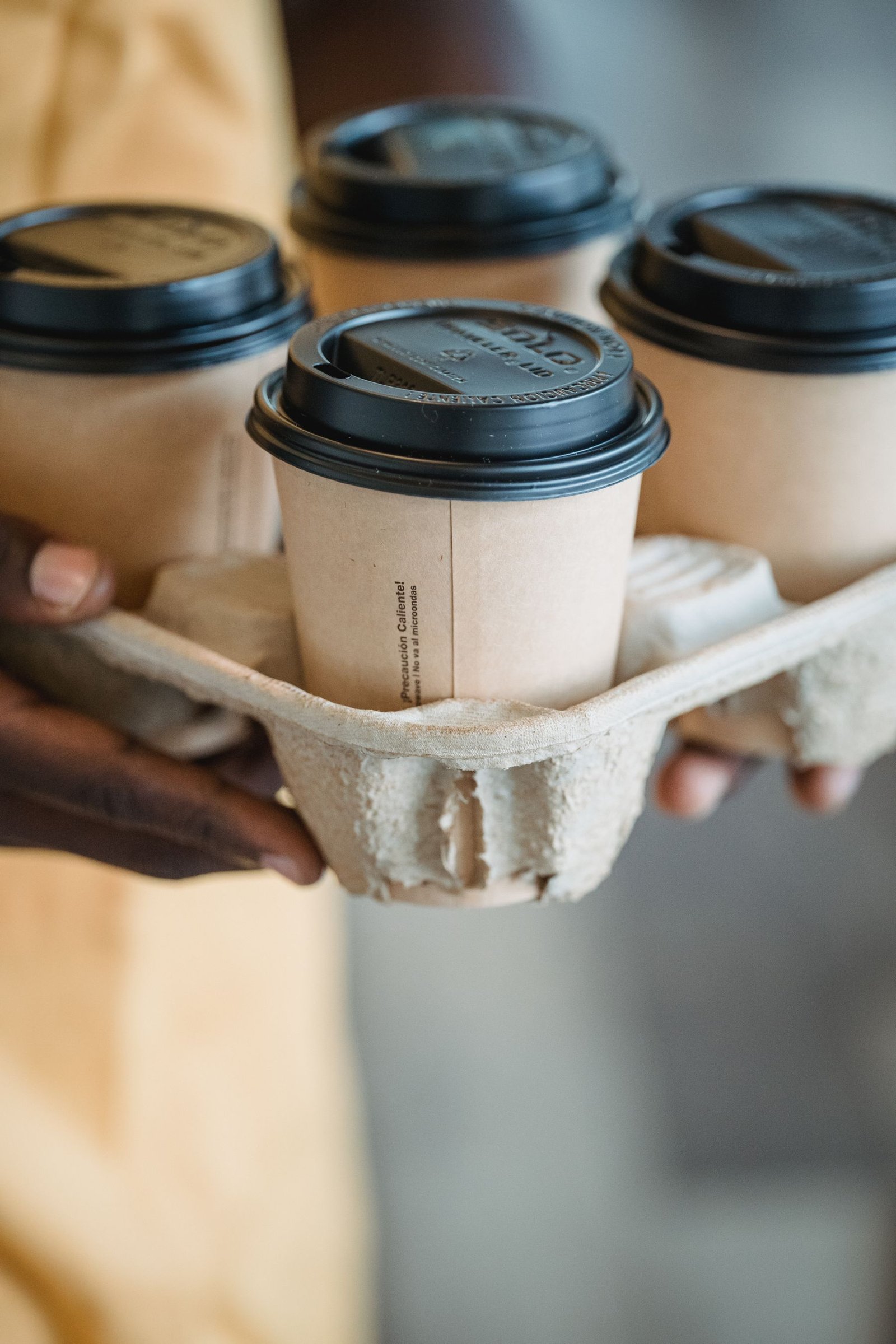 Takeaway coffees secured in a paper cup carrier