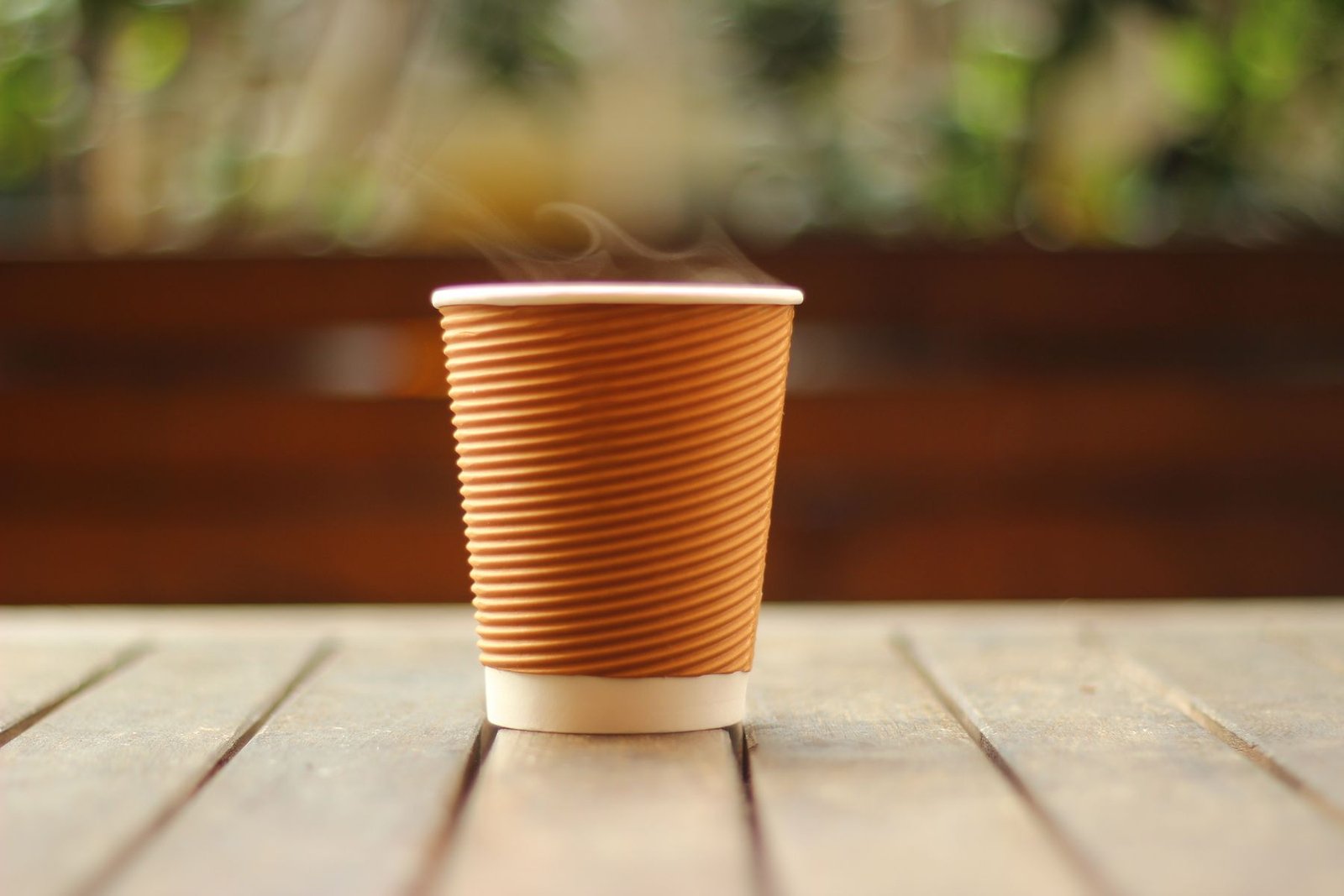 A takeaway coffee in a plain kraft paper cup