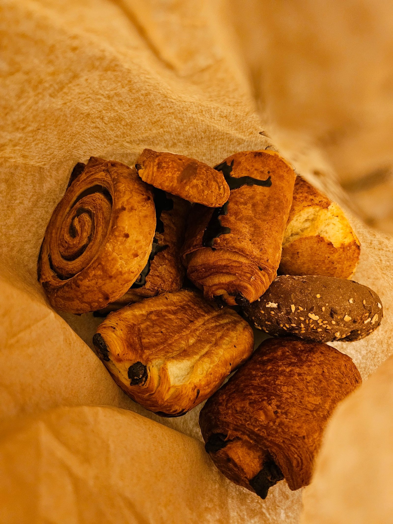 Fresh pastries packed together in a paper bag